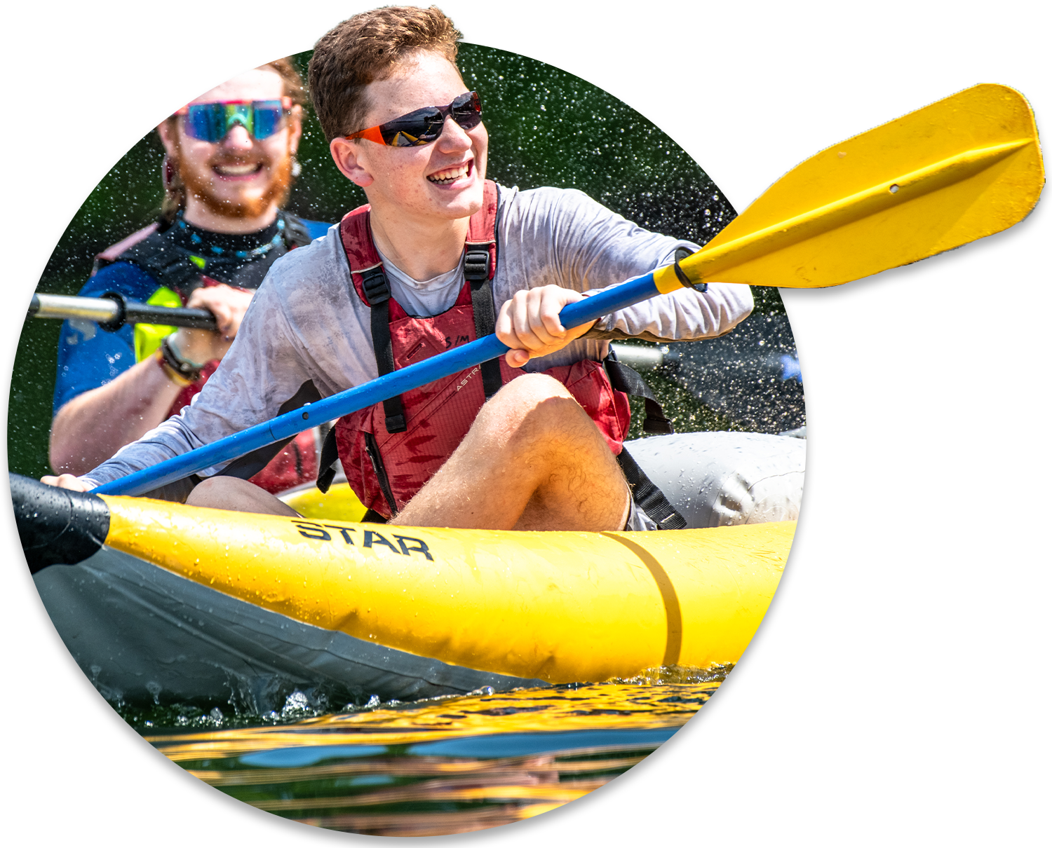 Two teenagers are laughing while kayaking